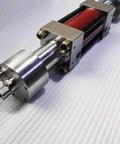 Waterjet intensifier pump assembly, red stainless steel, side view with mounting brackets and fittings.