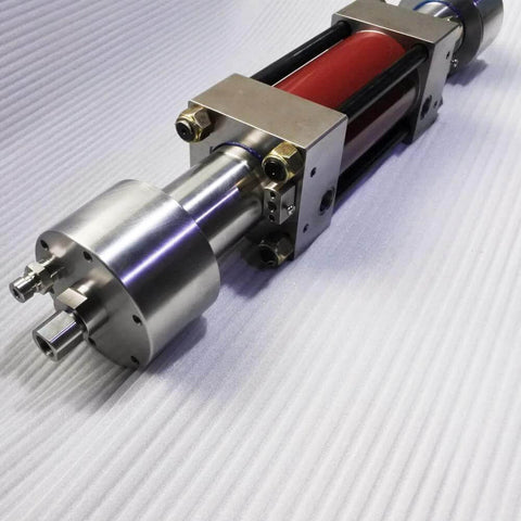 Waterjet intensifier pump assembly, red stainless steel, side view with mounting brackets and fittings.