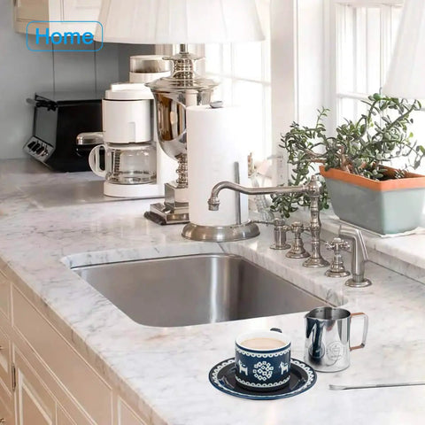20 Oz Milk Frothing Pitcher Stainless Steel 304 Durable Espresso Steaming Jug next to decorative cup on kitchen countertop