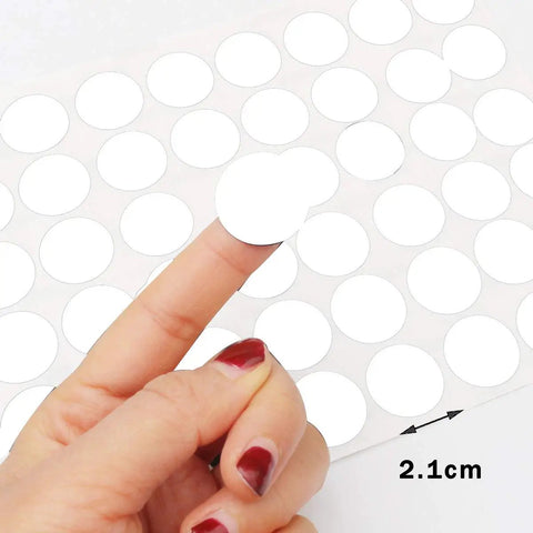 Screw Hole Stickers Three Sheet Pack For Hiding Screws And Fasteners Self Adhesive Caps being peeled from a sheet, size 2.1cm