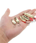 Hand holding part of 10 Piece Metal Spoons Lures Kit With Hooks Tackle Box Hard Fishing Lures Sequin Baits For Trout Panfish Bass