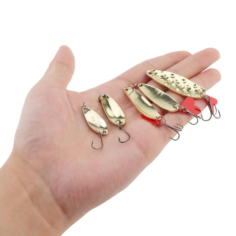 Hand holding part of 10 Piece Metal Spoons Lures Kit With Hooks Tackle Box Hard Fishing Lures Sequin Baits For Trout Panfish Bass