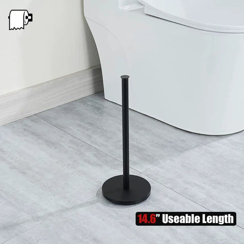Matte Black Stainless Steel Toilet Paper Storage Stand That Holds 3 Rolls Thick Zero Point Eight Millimeter Frame Built Tough Prevents Rust Easy Clean Bathroom Organizer Dispenser on bathroom floor next to toilet.