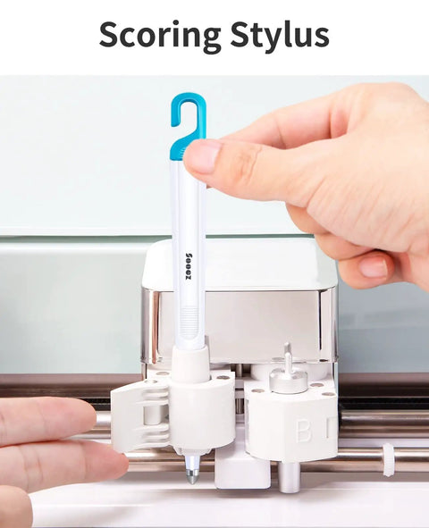 Scoring stylus being inserted into machine from Six Piece Vinyl Tool Kit For DIY Crafters With Scoring Stylus Weeder With Cap Scissors Tweezers Spatula And Scraper For Vinyl Paper And Iron On Projects.