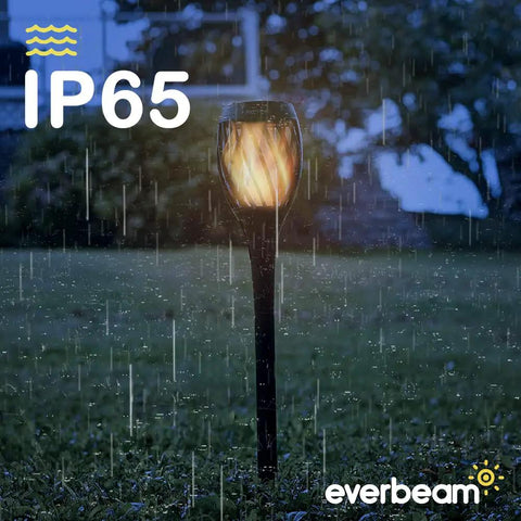 P2 Solar Flickering Flame Torch Light With Realistic Fire, IP65 Waterproof Outdoor Tiki Lamp in a garden during rain