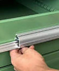 Close-up of hand operating the lock mechanism of Snag This Top Shelf Lockable Steel Tool Cabinet for secure storage.