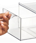 Close-up of a hand pulling out a drawer from Stackable Storage Box With 2 Pull Out Drawers Clear Plastic Bin For Closet Organization Linen Coat Bedroom Or Entryway Storage Space Saving Durable Translucent Organizer Lumiere Collection 2 Pack