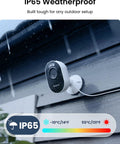 Lumus Outdoor Security Camera With 2K Color Night Vision Spotlight mounted outdoors in rainy weather showing IP65 rating.