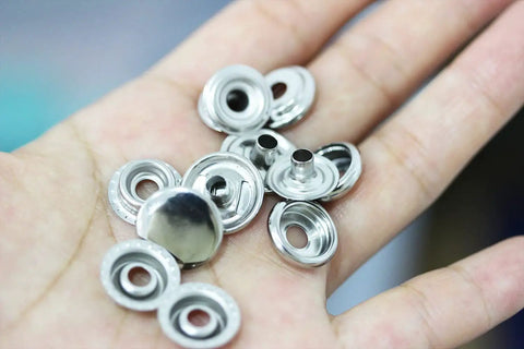 Close-up of 240 Pieces Stainless Steel Snap Fasteners 15mm Heavy Duty Set For Jeans Jackets Bags Leather And DIY Craft Projects