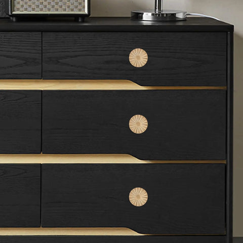 Three champagne bronze drawer knobs on a black dresser, showcasing the Ten Pack Kitchen Cabinet Knobs And Champagne Bronze Drawer Knobs Made From Heavy Duty Zinc Alloy Hardware That Delivers A Killer Finish And Hella Sturdy Feel For Any Modern Home Makeover Project.