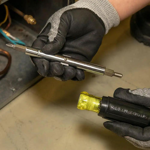 Technician holding 11-In-1 Multi-Bit Screwdriver And Nut Driver For HVAC Pros With Phillips Slotted Square And Schrader Bits