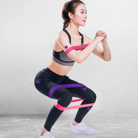 Woman using Five Piece Yoga Resistance Bands Set Foldable Silicone Bands With Strong Load Bearing For Gym Workouts and Bodybuilding