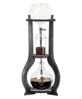 Kick Back And Sip Smooth Chills With This Sharp Cold Brew Drip Coffee Maker Crafted From A Borosilicate Pitcher And Real Wood Stand For Hassle Free Iced Coffee Runs That Come Out Fresh And Totally On Point Daily with a glass pitcher on a dark wood frame.
