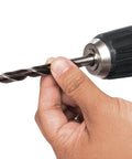 Close-up of hand holding drill bit for Ultra Compact 12V Max CXT Brushless Cordless Driver Drill With Smooth Handling And Rock Solid Motor For Knockout Torque And Serious Weekend Grind Sessions.