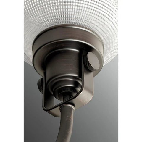 Close-up of Archie Collection One Light Pendant in Venetian Bronze with clear prismatic glass highlighting mount details