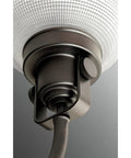 Close-up of Archie Collection 4-Light Bath Vanity Light With Clear Double Prismatic Glass Shades In Venetian Bronze Finish