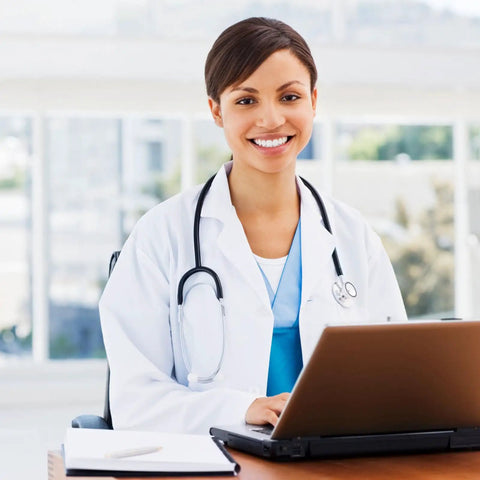 Woman in Women White Lab Coat For Medical Pros Pro Grade Long Sleeve Doctor Costume Style Button Closure using laptop