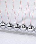 7 Ball Newton's Cradle Pendulum Desk Toy With Classic Swing And 30 Plus Second Swing Time, Chrome Iron Construction close-up