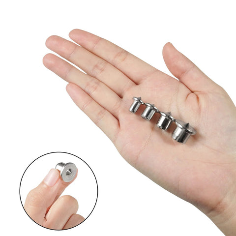 Hand holding Four Pieces from Eight Piece Dowel And Tenon Center Transfer Plugs Set For Woodworking, Heavy Duty Steel Alignment Pins With Chrome Finish, Includes 6mm 8mm 10mm 12mm Centers And 1/4 5/16 3/8 1/2 Inch Sizes For Precise Hole Alignment.