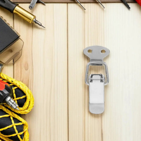 Versatile Stainless Steel Spring Loaded Toggle Latches For Secure Outdoor Furniture And Toolboxes with Easy Install Grip and Durable Heavy Duty Holding Power For Smokers Cabinets And Storage Boxes on a wooden surface.