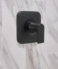 Genta LX Matte Black Shower Trim Kit with Lever Handle installed on marble tile wall