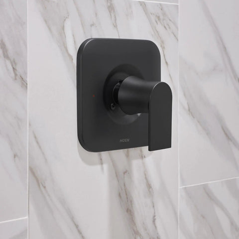 Genta LX Matte Black Shower Trim Kit with Lever Handle installed on marble tile wall