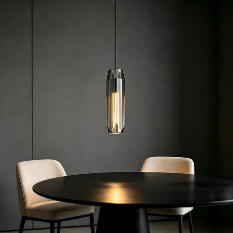 PRTSER 11.8" Modern Pendant Light Fixture with Smoke Gray Crystal Lampshade hangs above a round black table and beige chairs.
