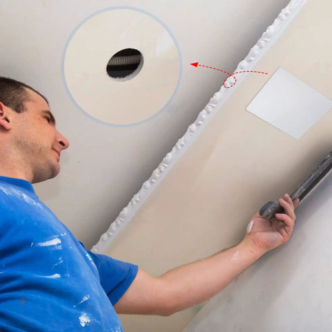 Man installing Top Shelf Six Pack White Ceiling Cover Plates 12 Inch Wall Hole Covers over a drywall hole.