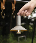 Hand holding rechargeable outdoor rugged camping flashlight three in one lantern with 3100mAh power IP66 waterproof tent light