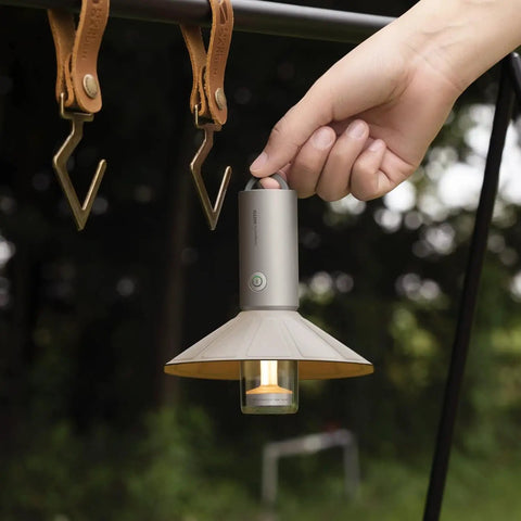 Hand holding rechargeable outdoor rugged camping flashlight three in one lantern with 3100mAh power IP66 waterproof tent light