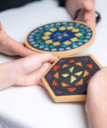 Hands holding a colorful round and hexagon mosaic, part of Set of 2 Mosaic Kits for Adults, Diy Stained Glass Craft for Beginners.