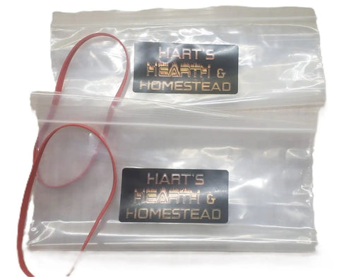 Close-up of two clear zip-lock pouches with branding, part of Foldable 10L Water Containers 2 Pack With Spigot And Pouch For Camping, Hiking And Emergency Prep BPA Free Durable Outdoor Water Jug That Folds Flat When Empty And Keeps Hydration On The Go.