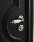 Close-up of white ceramic split door lock set on black door with keyed alike bedroom interior handles, smooth operation