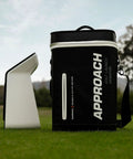 Approach R50 Golf Launch Monitor And Simulator Bundle featuring display case on grass with trees in background