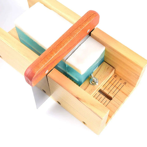 Close-up of adjustable wood cutter from DIY Soap Making Cutting Kit With Two Purple Silicone Molds In Wood Boxes and soap bar inside.