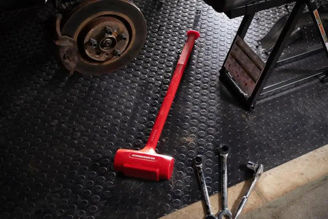 One Piece Sledge Head Dead Blow Hammer 6-1/2 Lb Made In USA Non Sparking Polyurethane Body with steel shot chamber in garage