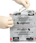 Front view of North American Rescue HyFin Vent Chest Seal Twin Pack being opened by gloved hands.