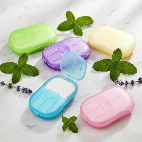 Grab and Go Disposable Soap Sheets Set, 5 Boxes of Fragrant Paper Soap in assorted colors with herbs on marble surface.