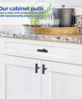Matte Black 2 Inch Cabinet Knobs 30 Pack Stainless Steel Kitchen Cabinet Knobs installed on white kitchen cabinets with round edge.