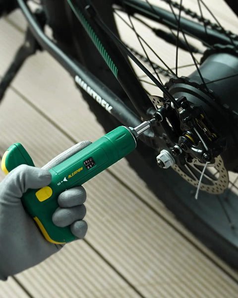 Quarter Inch Torque Wrench Set With Hidden 12-Piece S2 Steel Bits In T-Handle adjusting bike wheel.