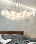 Polished Chrome And Distinctive Glass Pendant Ceiling Light With Energy Efficient Led Bulbs hanging over a modern bed in bedroom.