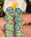 Score These Hella Rad Lampwork Glass Round Spacer Beads With Big Center Holes Perfect For DIY Jewelry Making Kicking Up Your Bracelet And Necklace Crafting Vibes Today, beaded spacer in green and blue floral patterns.