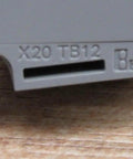 Close-up of X20 12 Pin Terminal Block With Push In Connectors, showcasing the label and push-in slots for 10 Amp wiring.