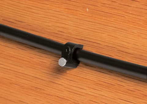 Close-up of Patio Drip Irrigation Kit With Faucet Connection, 42-Piece Set, black one quarter inch tubing fixed on wood surface