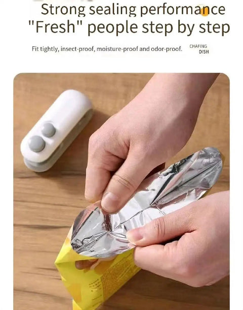 Hands using Portable Double Function Bag Sealer And Cutter With Usb Cable to seal a foil snack bag securely.