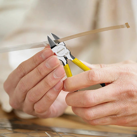 BOOSDEN Wire Cutter, 6.5-inch, yellow-handled side cutters cutting a flat ribbon cable