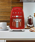 Boost Your Daily Grind With This Smooth Operator Retro Drip Coffee Maker Featuring 10 Cup Glass Carafe Programmable Auto Start Keep Warm Plate And Dual Strength Settings In Bold Red on a kitchen counter.