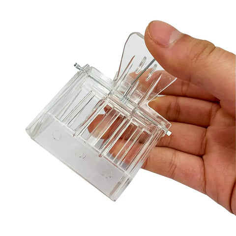 Hand holding Clear Queen Bee Cage Catcher Clip Set For Beekeeping Tools Beekeeping Essentials Spring Loaded Queen Grabber with plastic build