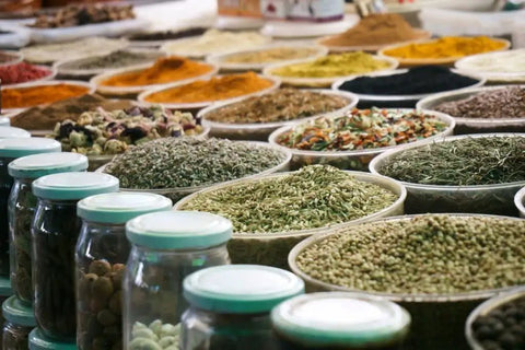 Display of various herbal powders and spices similar to Root Extract Powder 100 Grams Non Edible Use in bowls and jars.