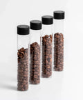 Keep Your Grind Fresh With This Premium Airtight Coffee Bean Storage Tube Set Featuring Four Smart Glass Jars And Clean Counter Display One Way Valve Seals In Aroma For Smooth Daily Brewing - four glass tubes with coffee beans